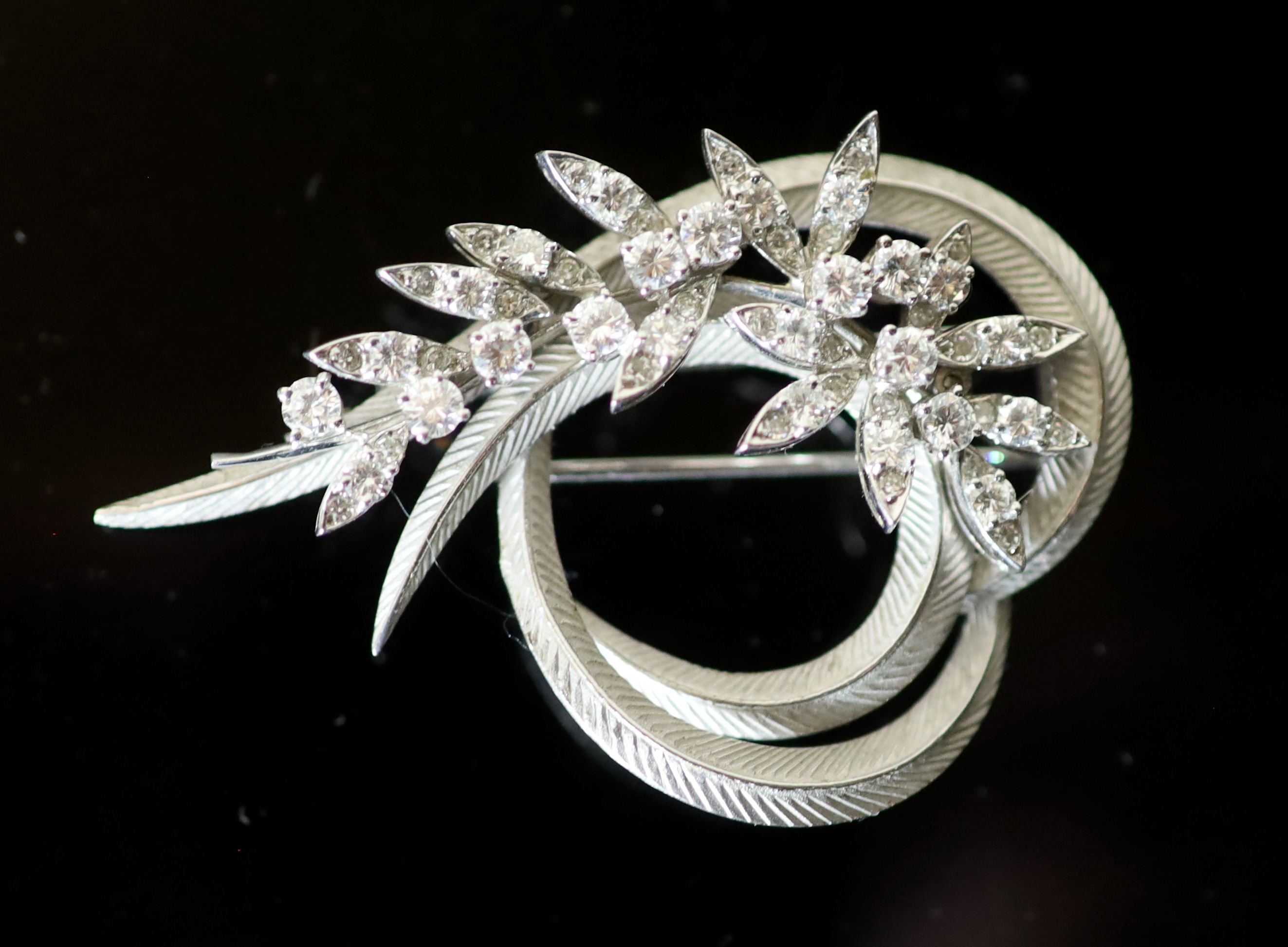 A mid 20th century French 18ct white gold and diamond set foliate scroll clip brooch,